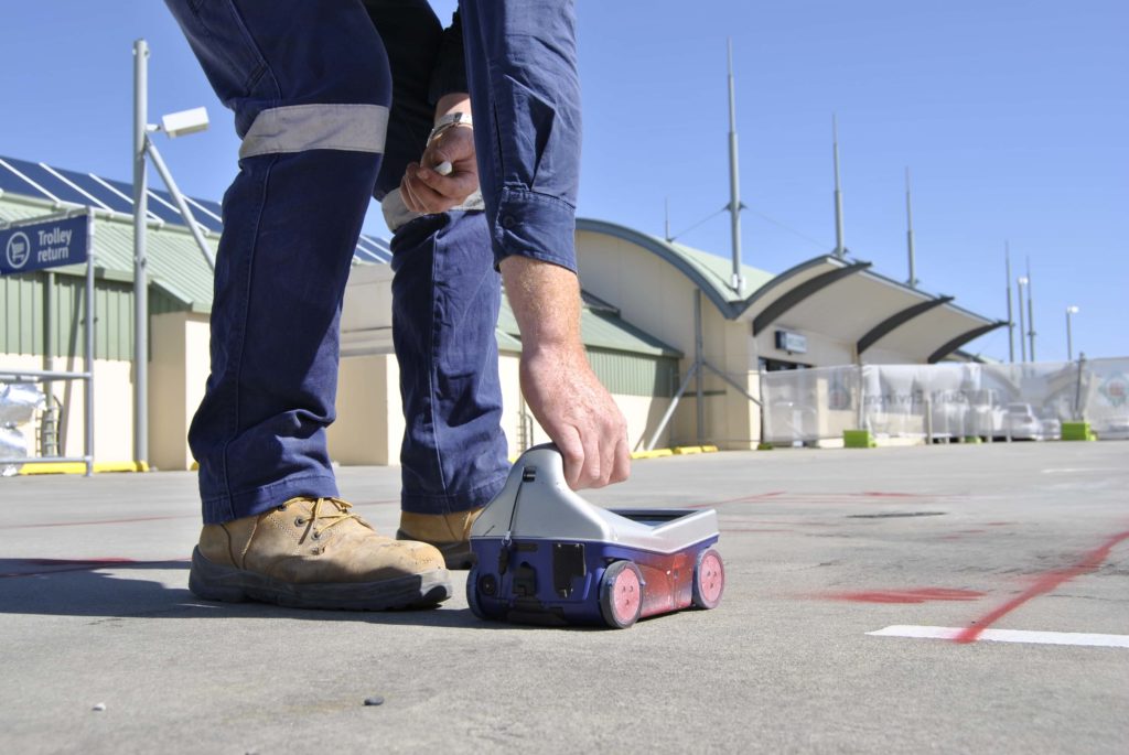Concrete scanner scannnig concrete on ground